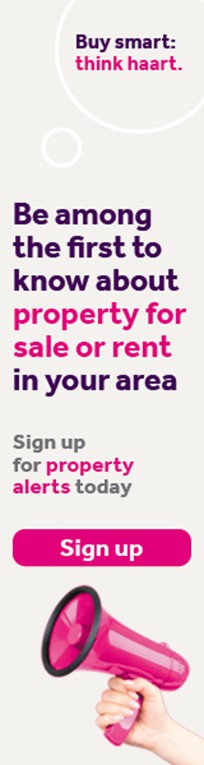 A hand holding a pink megaphone emphasises a property alert message from haart