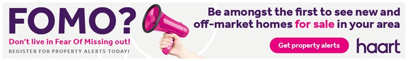 A hand holding a pink megaphone emphasises a property alert message from haart