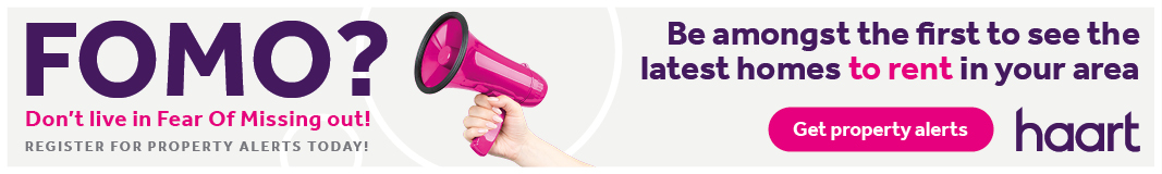 A hand holding a pink megaphone emphasises a property alert message from haart